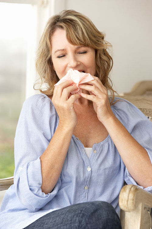 person sneezing due to mold problem in their home